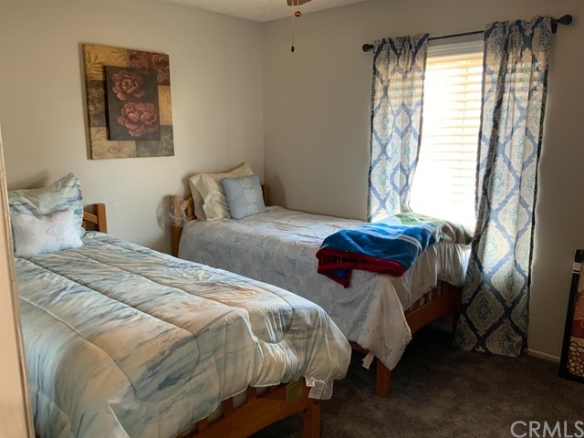 9450 Mango Avenue Hesperia, CA 92345 - Photo 8 of 14 a bedroom with two beds and a window