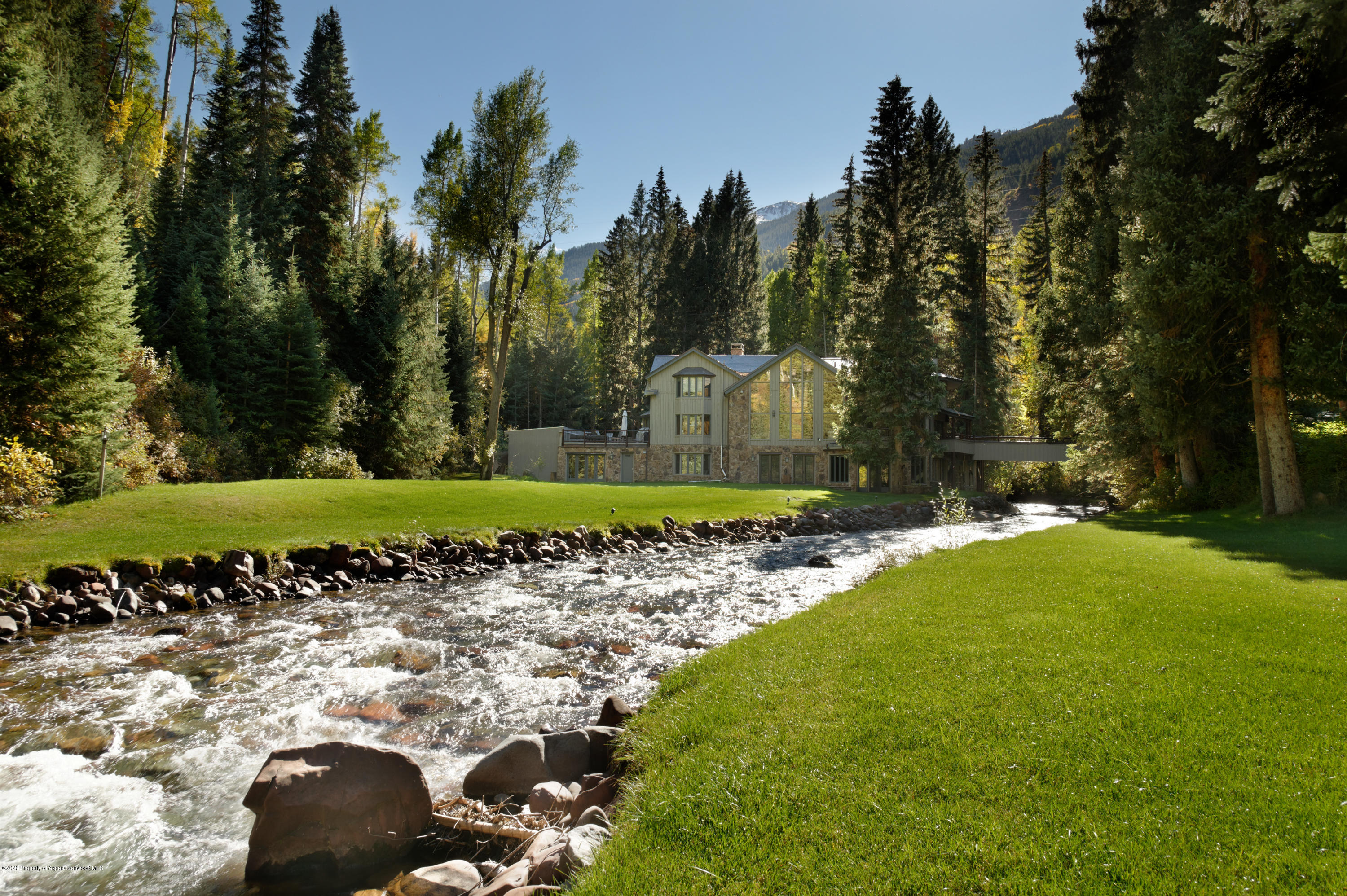 a view of a yard with yellow lighting