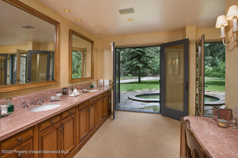 201 Midnight Mine Road Aspen, CO 81611 - Photo 26 of 40 a bathroom with a granite countertop sink and a large mirror
