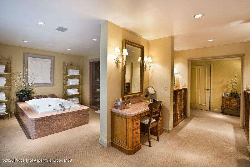 201 Midnight Mine Road Aspen, CO 81611 - Photo 29 of 40 a living room with furniture a flat screen tv and a table