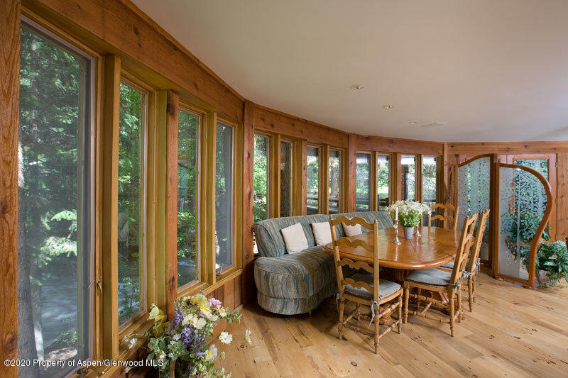 201 Midnight Mine Road Aspen, CO 81611 - Photo 31 of 40 a dining room with furniture window and wooden floor