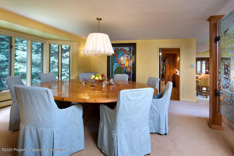 201 Midnight Mine Road Aspen, CO 81611 - Photo 32 of 40 a view of a dining room with furniture and chandelier
