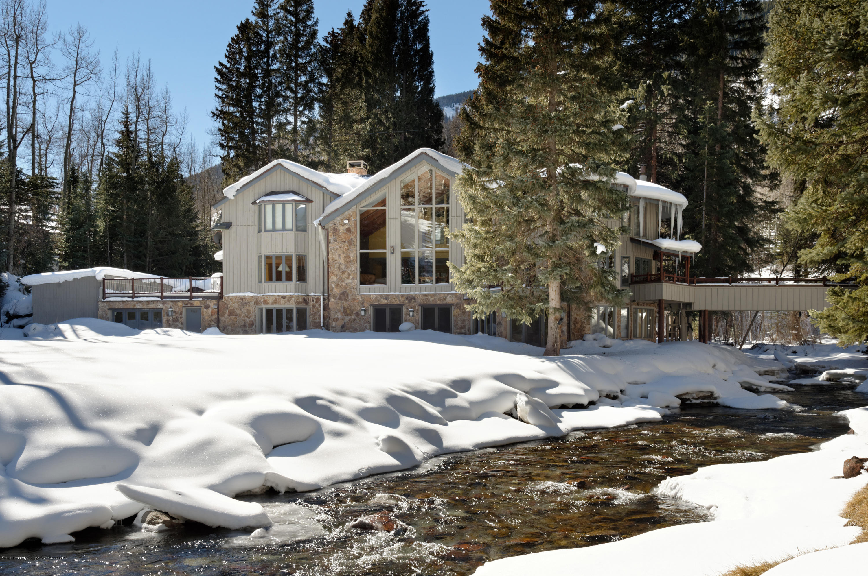 201 Midnight Mine Road Aspen, CO 81611 - Photo 33 of 40 a view of a white house with a yard covered in snow