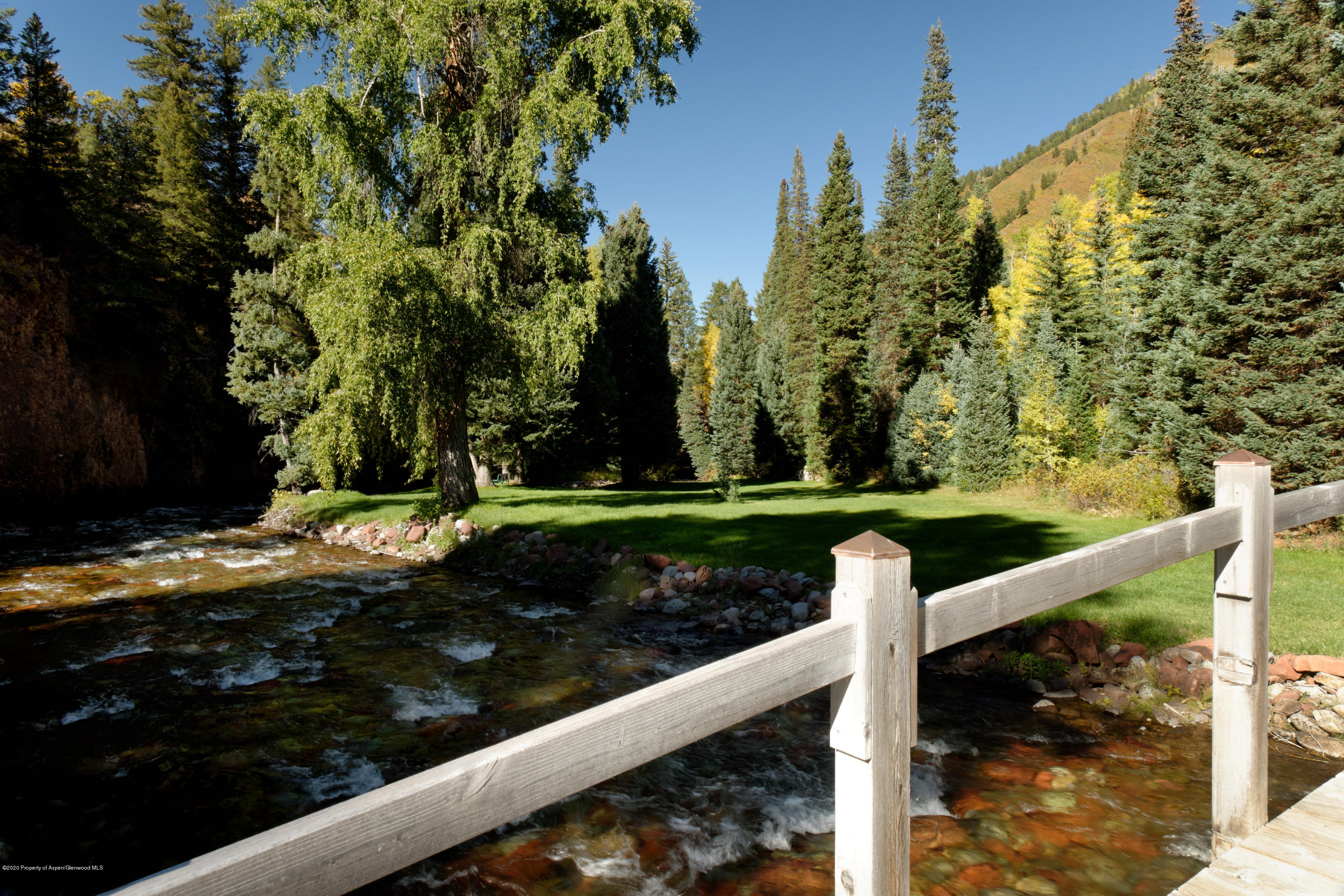 201 Midnight Mine Road Aspen, CO 81611 - Photo 8 of 40 a view of a garden with wooden fence