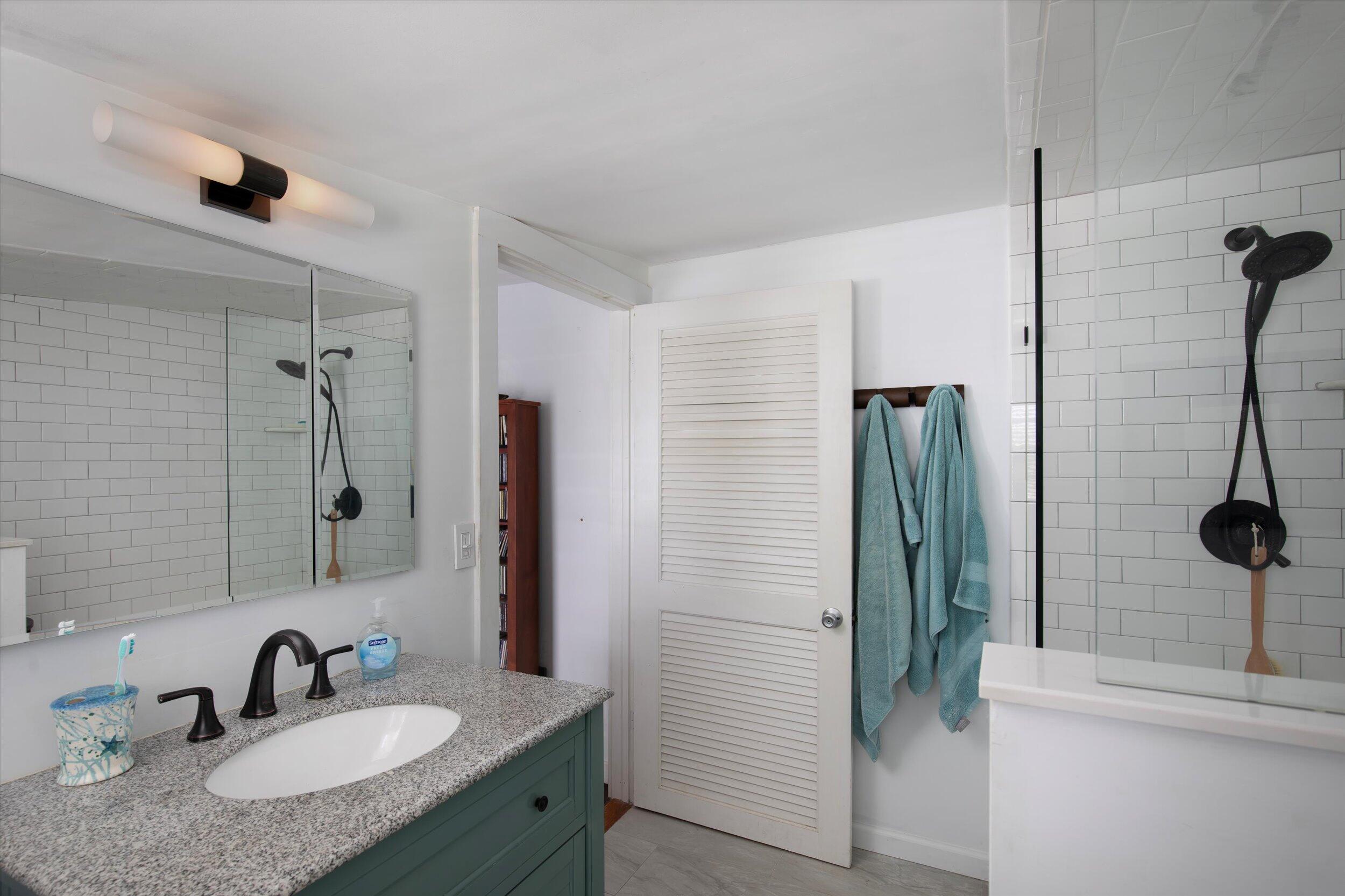 900 White Street, Unit 2 Key West, FL 33040 - Photo 11 of 24 a bathroom with a granite countertop sink and a mirror