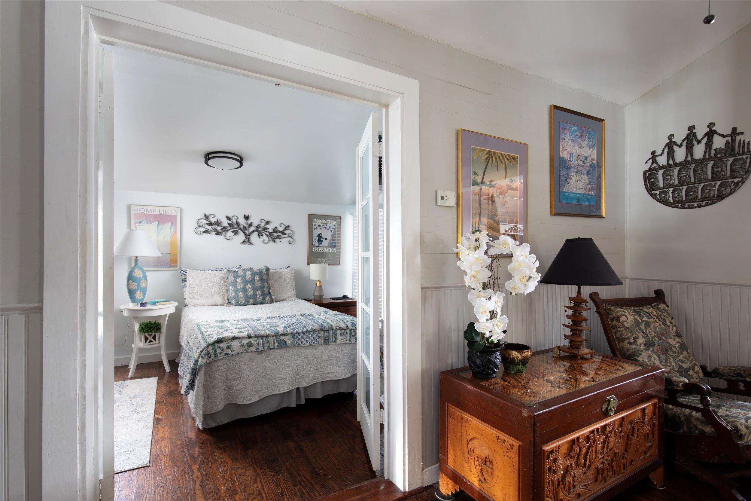 900 White Street, Unit 2 Key West, FL 33040 - Photo 12 of 24 a bedroom with a bed and wooden floor