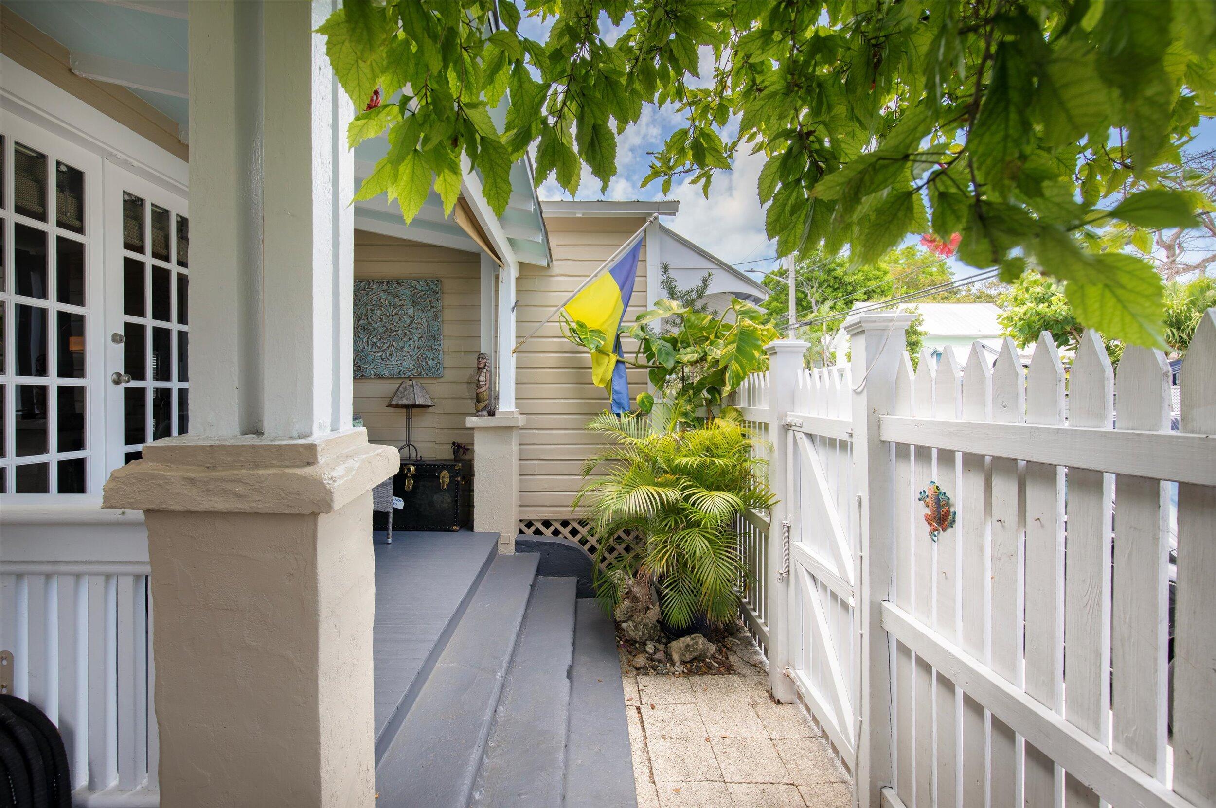 900 White Street, Unit 2 Key West, FL 33040 - Photo 21 of 24 a view of a house with plants and wooden fence