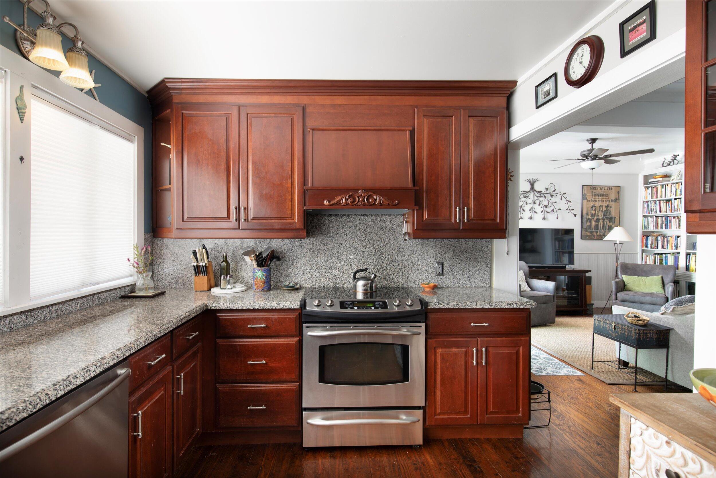 900 White Street, Unit 2 Key West, FL 33040 - Photo 4 of 24 a kitchen with stainless steel appliances granite countertop a stove a sink and a microwave