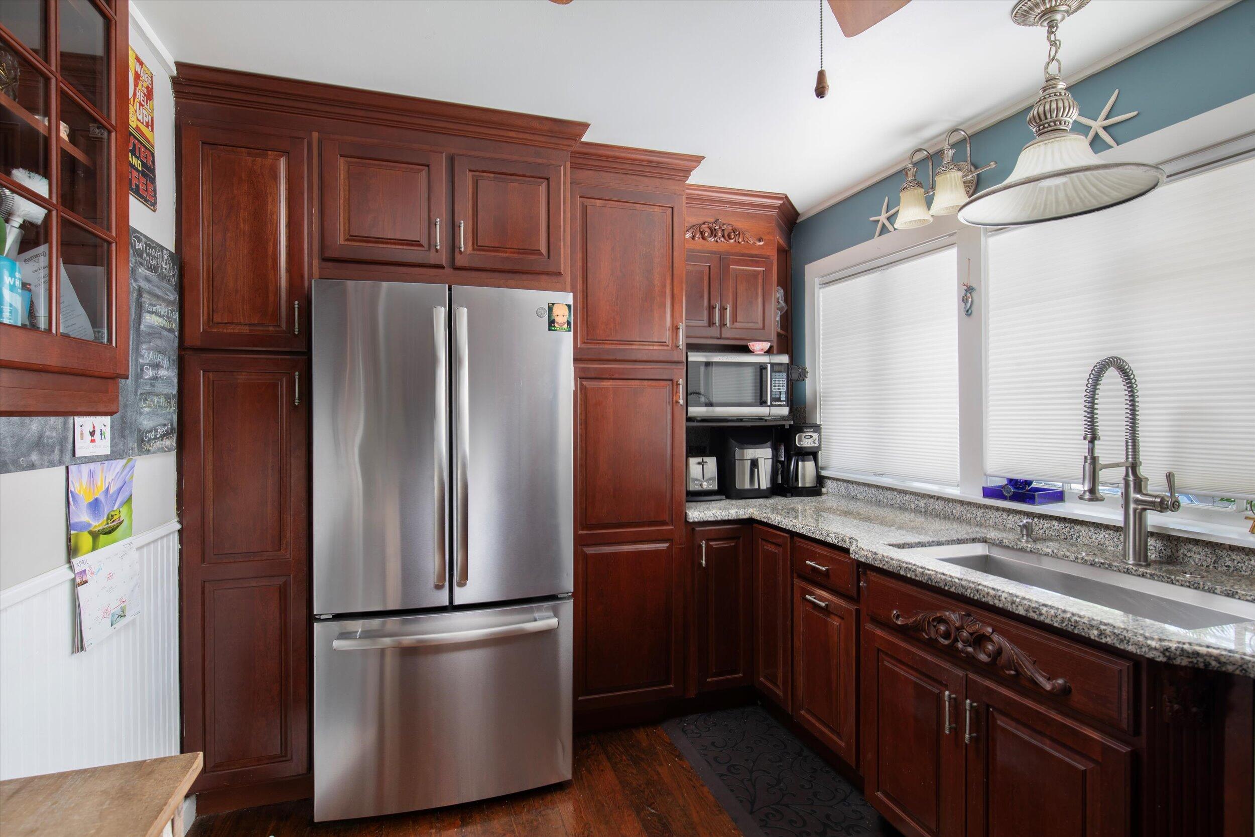 900 White Street, Unit 2 Key West, FL 33040 - Photo 5 of 24 a kitchen with stainless steel appliances granite countertop a refrigerator a sink and wooden cabinets