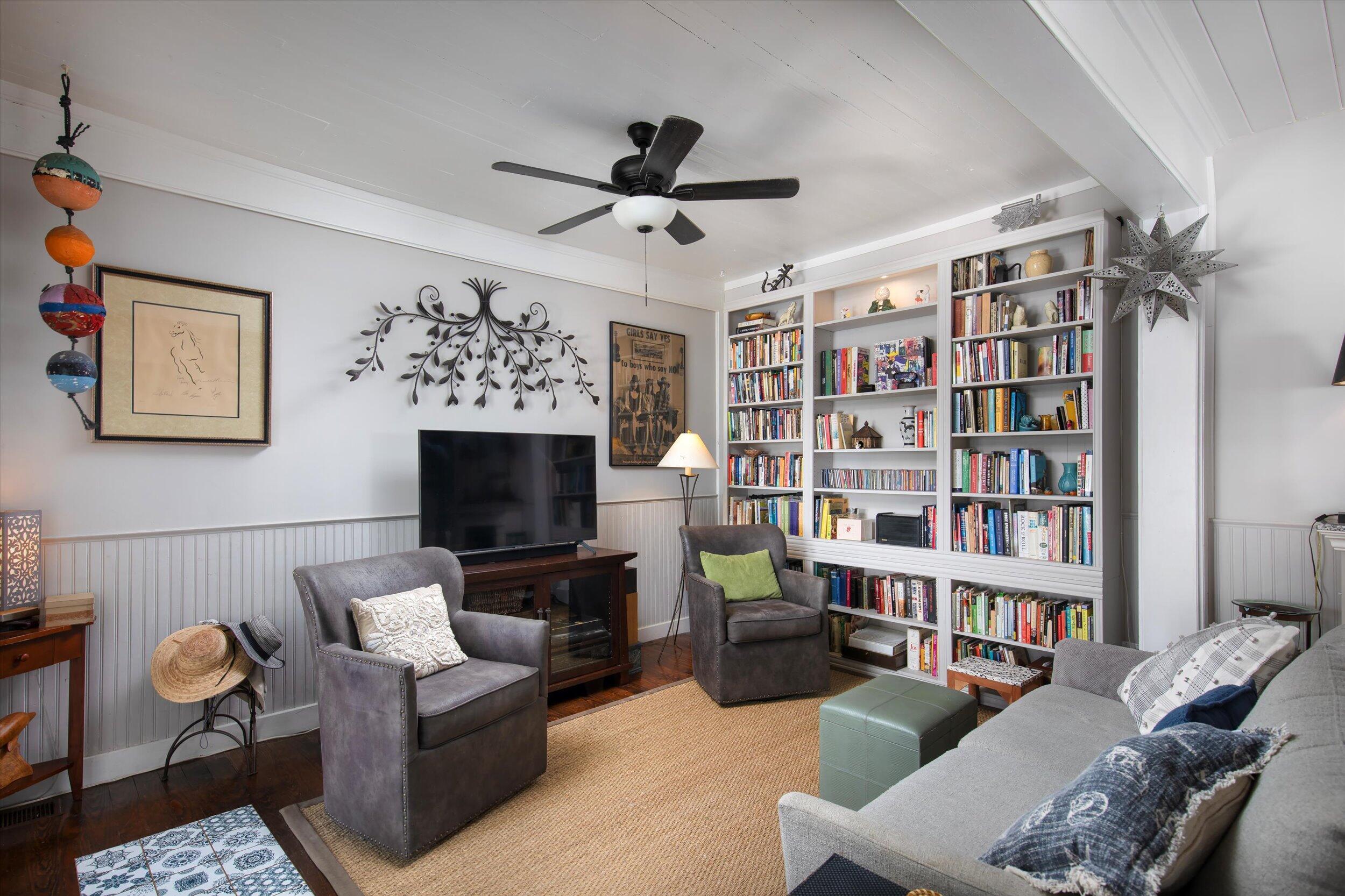 900 White Street, Unit 2 Key West, FL 33040 - Photo 7 of 24 a living room with furniture a rug and a book shelf