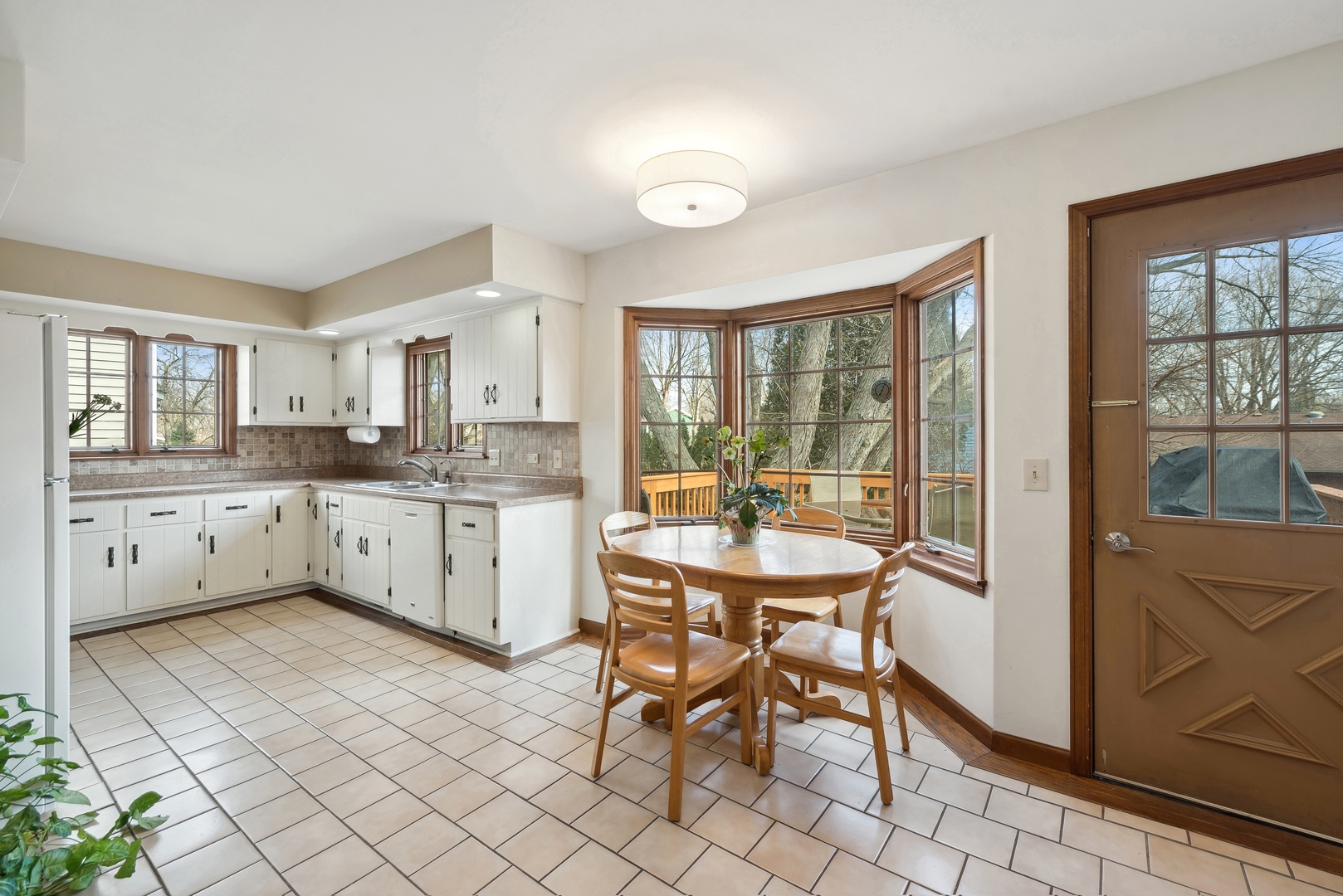 243 South Wulff Street Cary, IL 60013 - Photo 8 of 27 a kitchen with a sink and chairs
