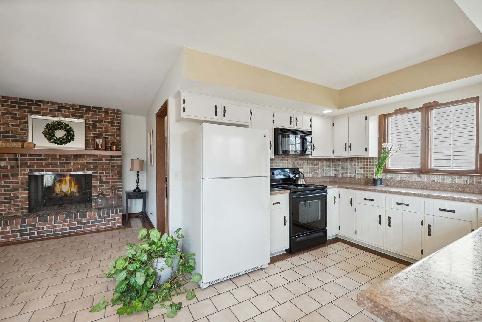 243 South Wulff Street Cary, IL 60013 - Photo 10 of 27 a kitchen with granite countertop a refrigerator a stove a sink and a cabinets