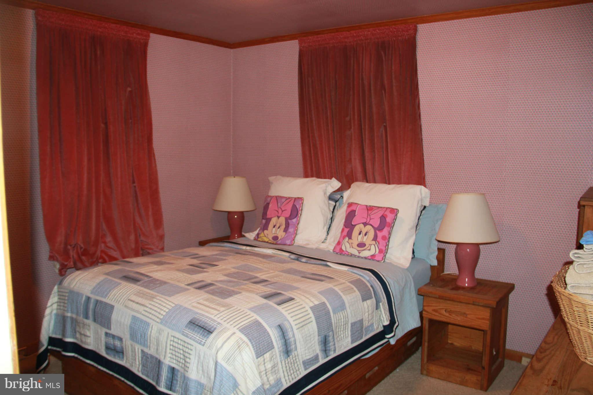 6502 Sharon Road Baltimore, MD 21239 - Photo 11 of 14 a bedroom with a bed and a table