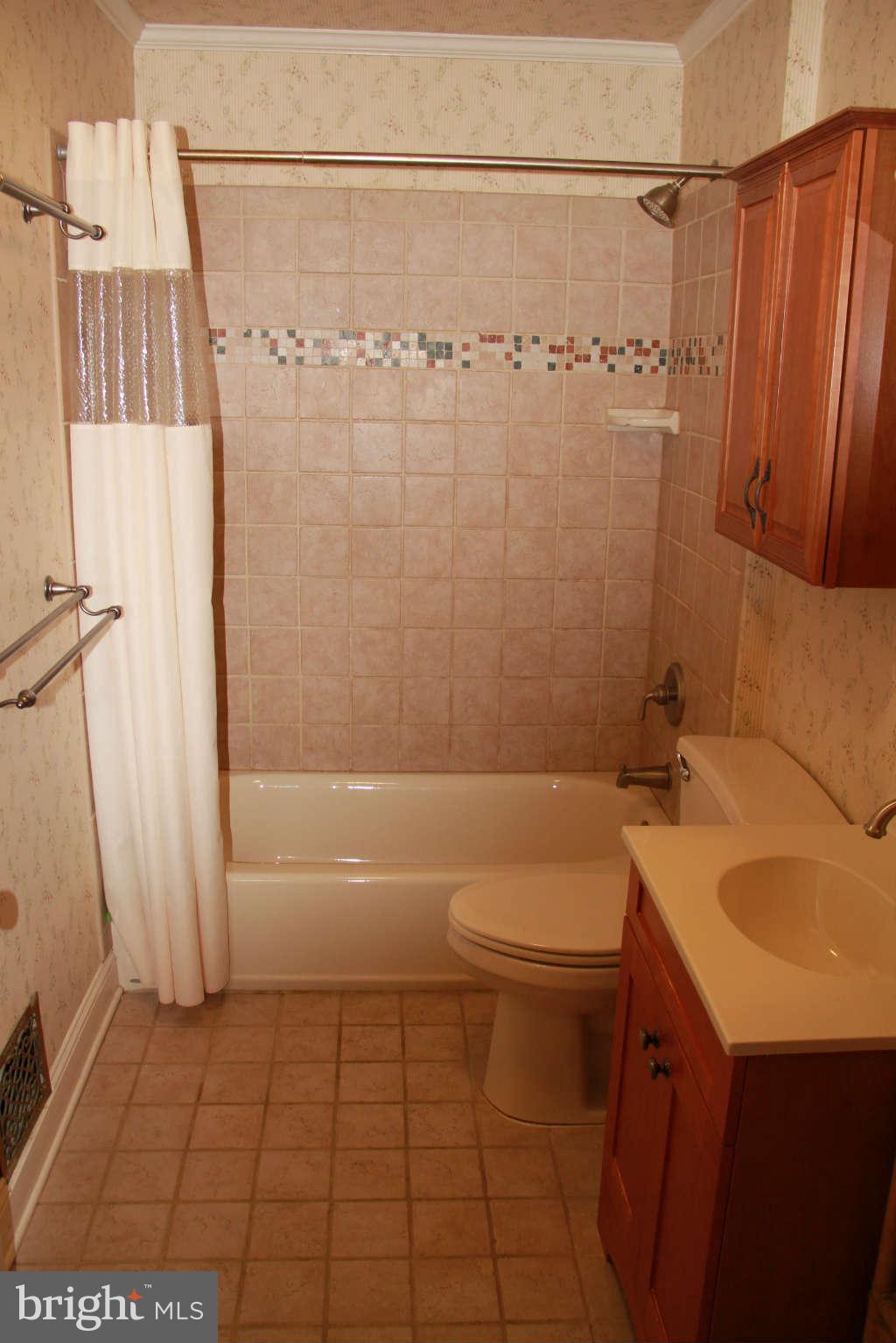 6502 Sharon Road Baltimore, MD 21239 - Photo 12 of 14 a bathroom with a sink a toilet and shower