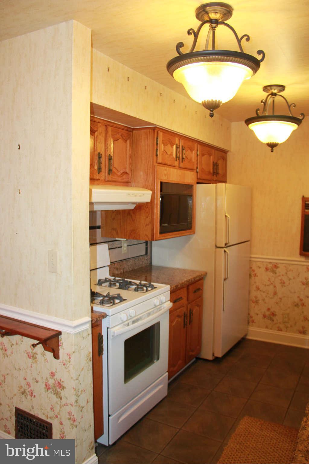 6502 Sharon Road Baltimore, MD 21239 - Photo 6 of 14 a kitchen with stainless steel appliances granite countertop a stove and a refrigerator