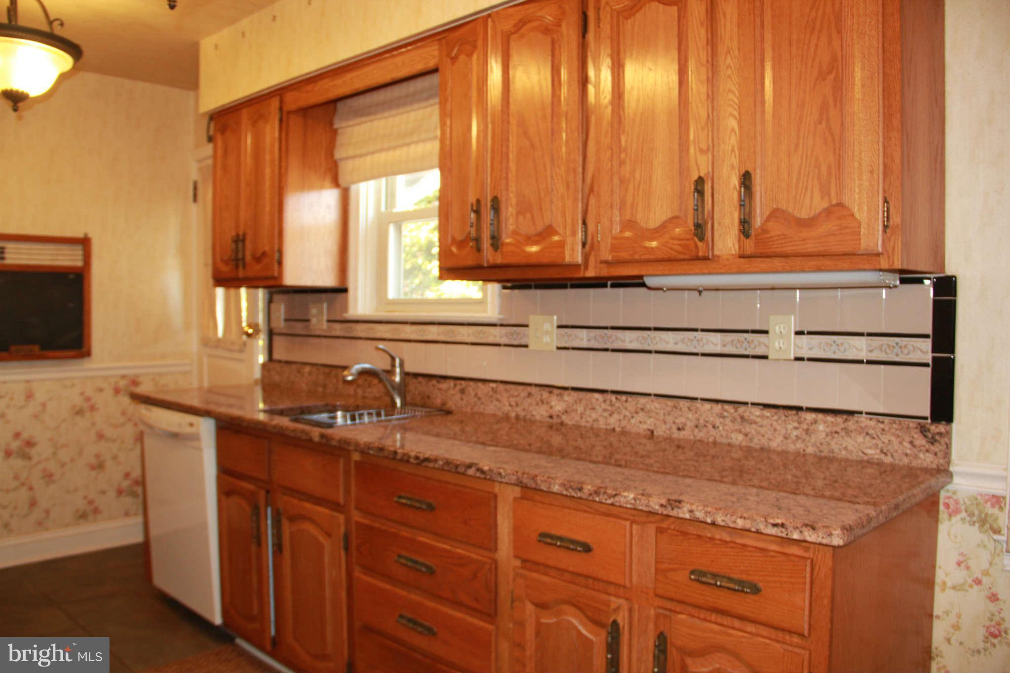 6502 Sharon Road Baltimore, MD 21239 - Photo 7 of 14 a kitchen with stainless steel appliances granite countertop a sink and a microwave