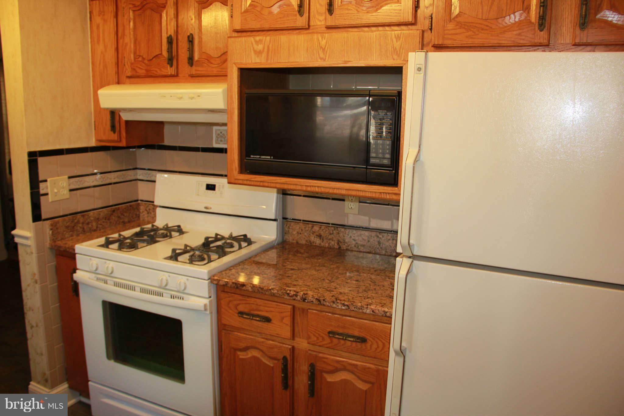 6502 Sharon Road Baltimore, MD 21239 - Photo 8 of 14 a stove top oven sitting inside of a kitchen
