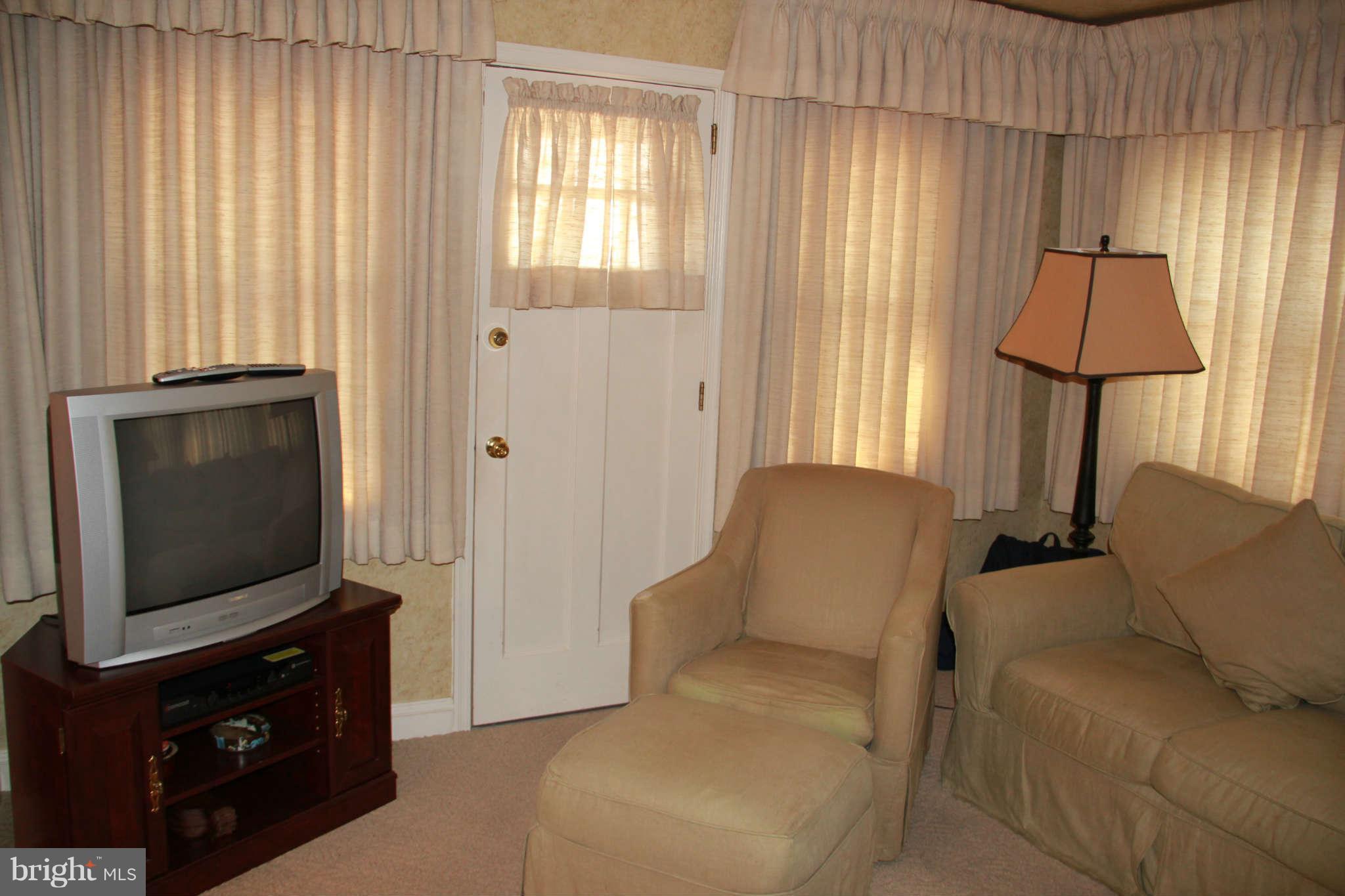 6502 Sharon Road Baltimore, MD 21239 - Photo 9 of 14 a living room with furniture and a flat screen tv