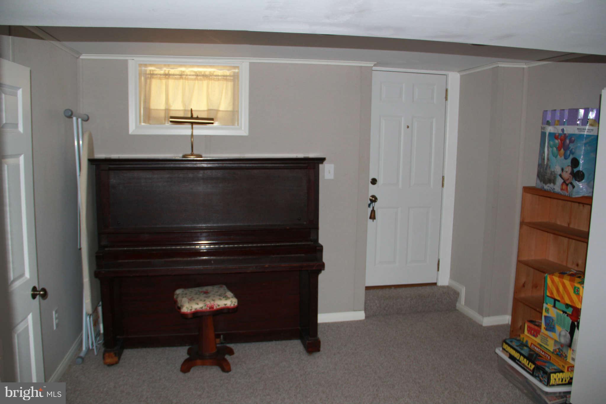 6502 Sharon Road Baltimore, MD 21239 - Photo 10 of 14 a room with a dresser and a window
