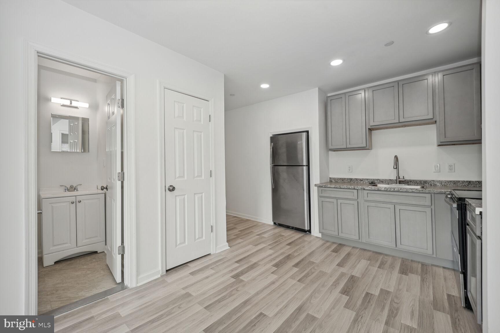 1642 16th Street Southeast, Unit 3 Washington, DC 20020 - Photo 9 of 22 a kitchen with stainless steel appliances granite countertop a refrigerator and a stove top oven