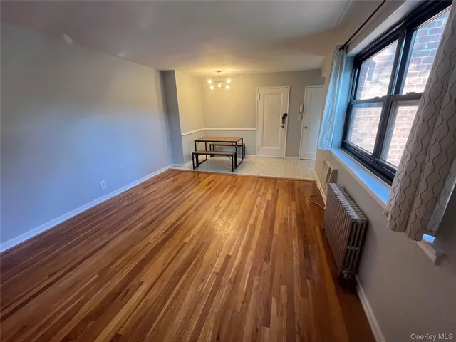 a view of a room with wooden floor and staircase
