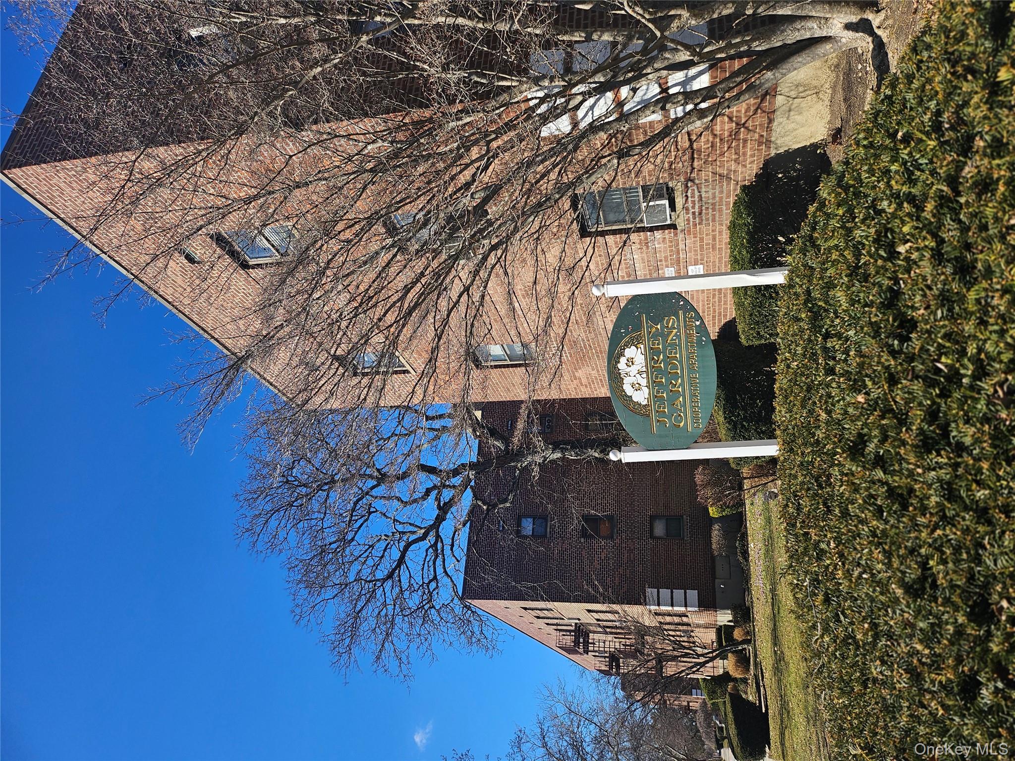 46-40 216th Street, Unit 3B Queens, NY 11361 - Photo 2 of 11 a front view of a house with garden