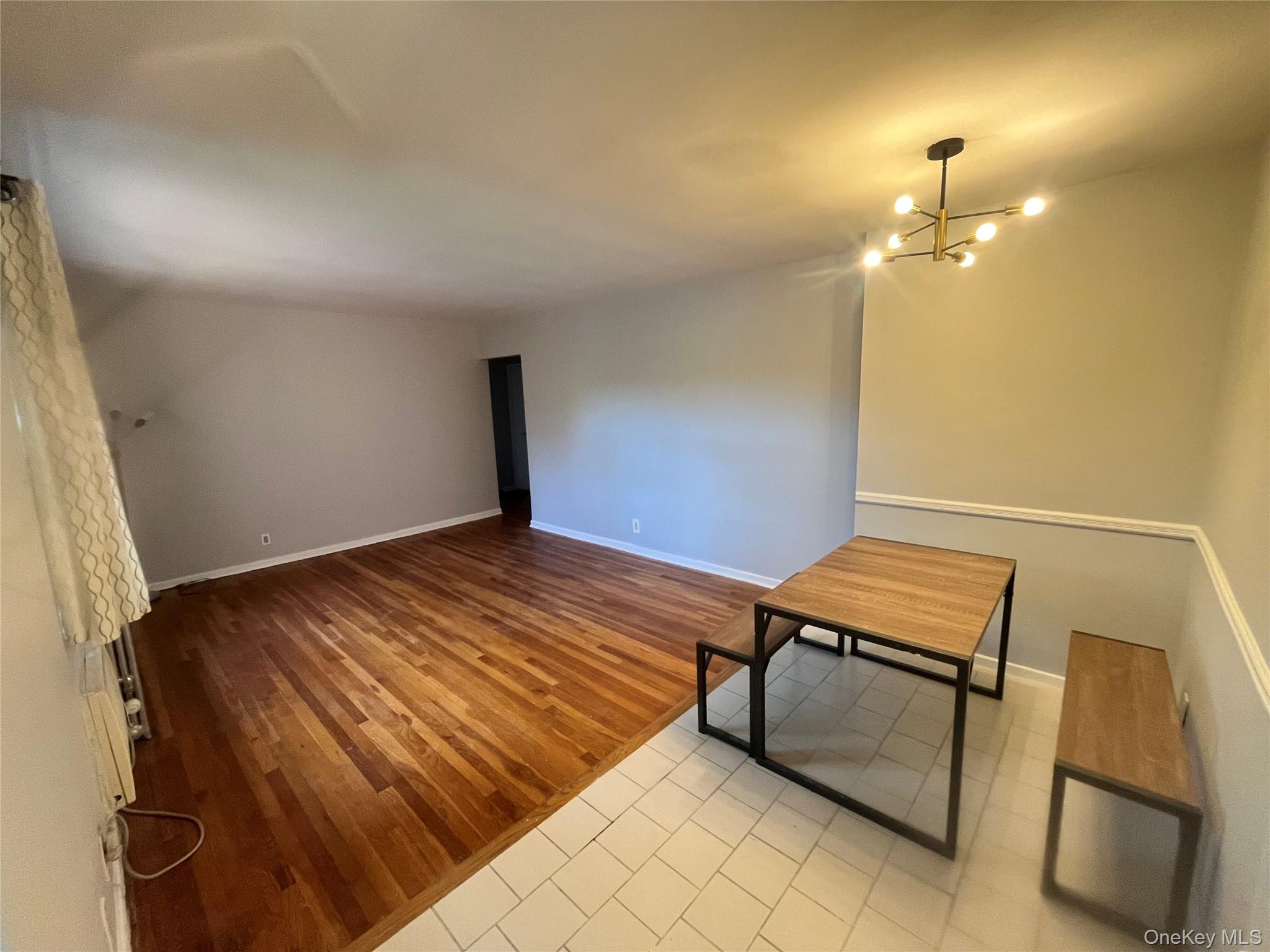 46-40 216th Street, Unit 3B Queens, NY 11361 - Photo 4 of 11 a room with a bed and a chair