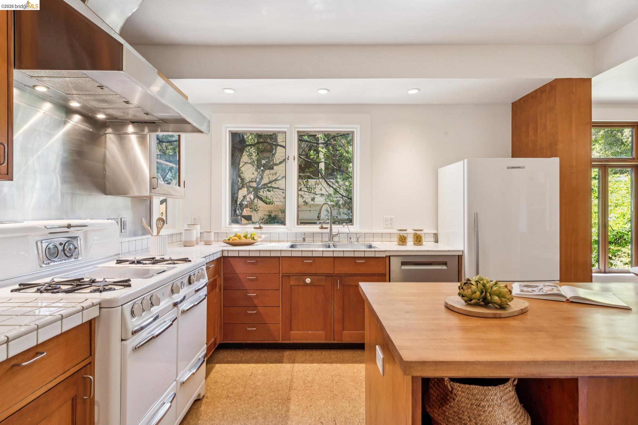 1490 Arch Street Berkeley, CA 94708 - Photo 19 of 57 a kitchen with stainless steel appliances granite countertop a sink stove and refrigerator