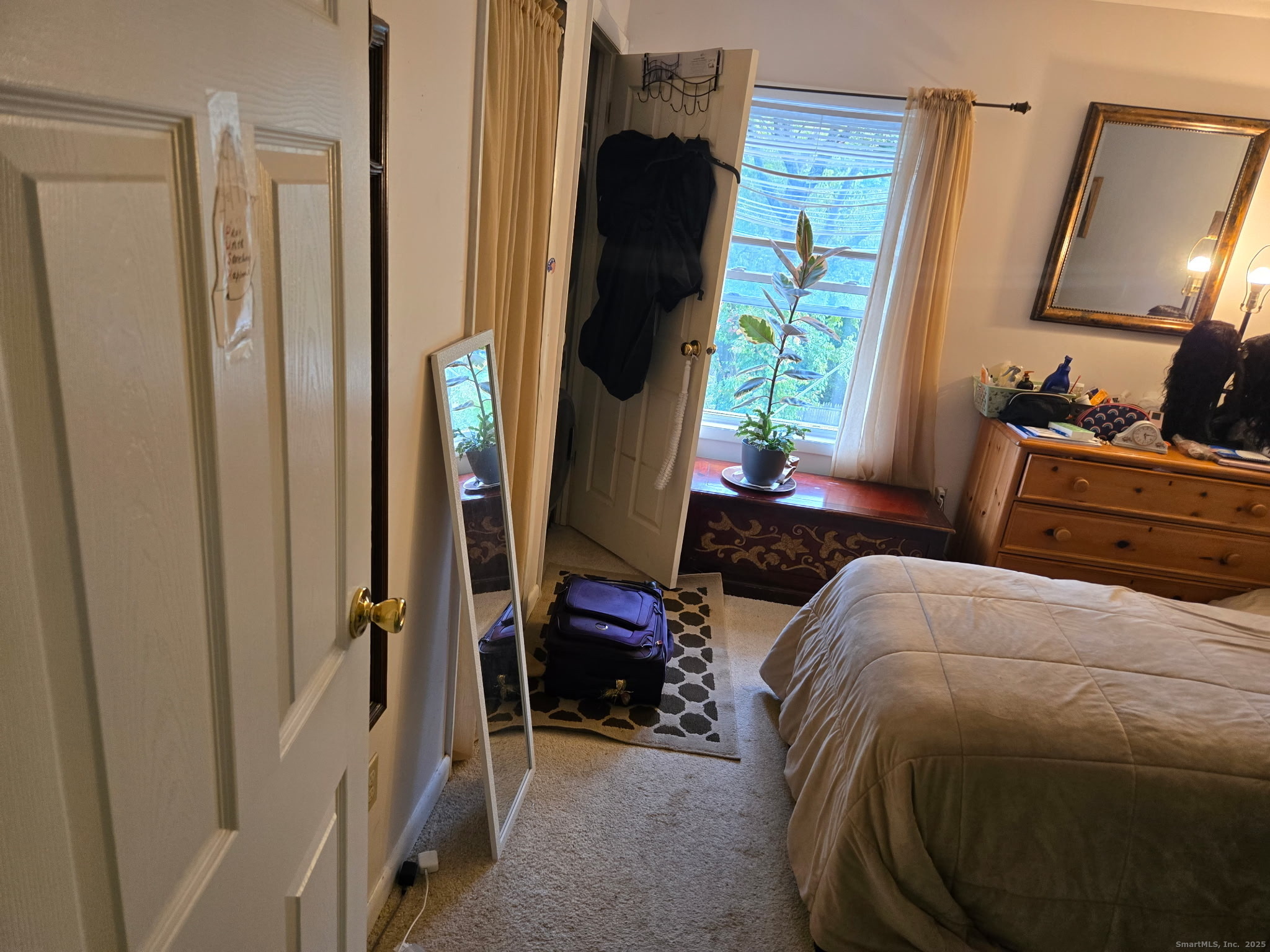 93 Spruce Street, Unit 11 Stamford, CT 06902 - Photo 2 of 6 a bedroom with a bed and a mirror