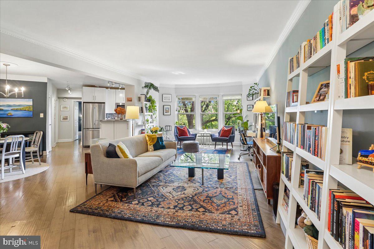 a living room with lots of furniture and a book shelf