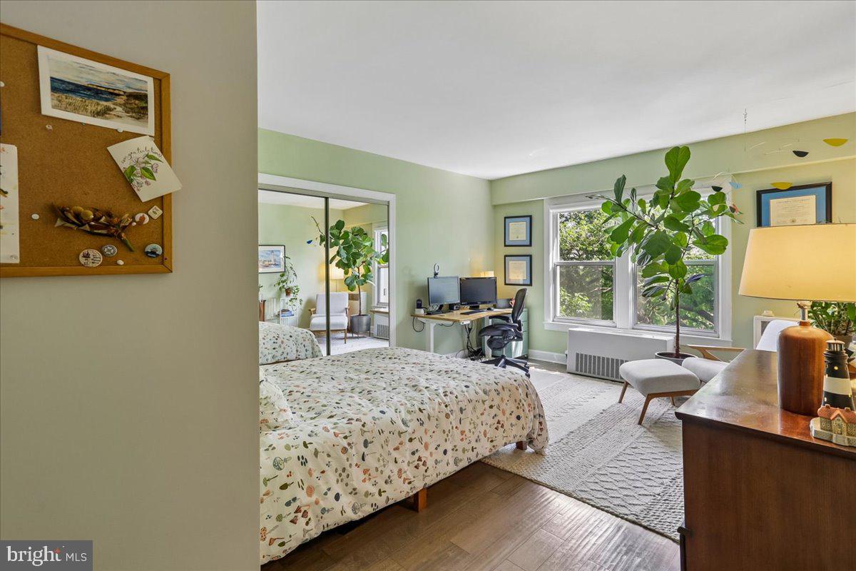 2500 Q Street Northwest, Unit 605 Washington, DC 20007 - Photo 21 of 48 a bedroom with a bed and wooden floor