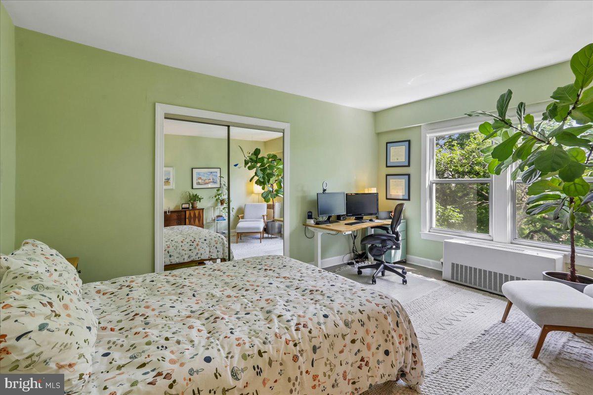 2500 Q Street Northwest, Unit 605 Washington, DC 20007 - Photo 23 of 48 a bedroom with a bed and large windows