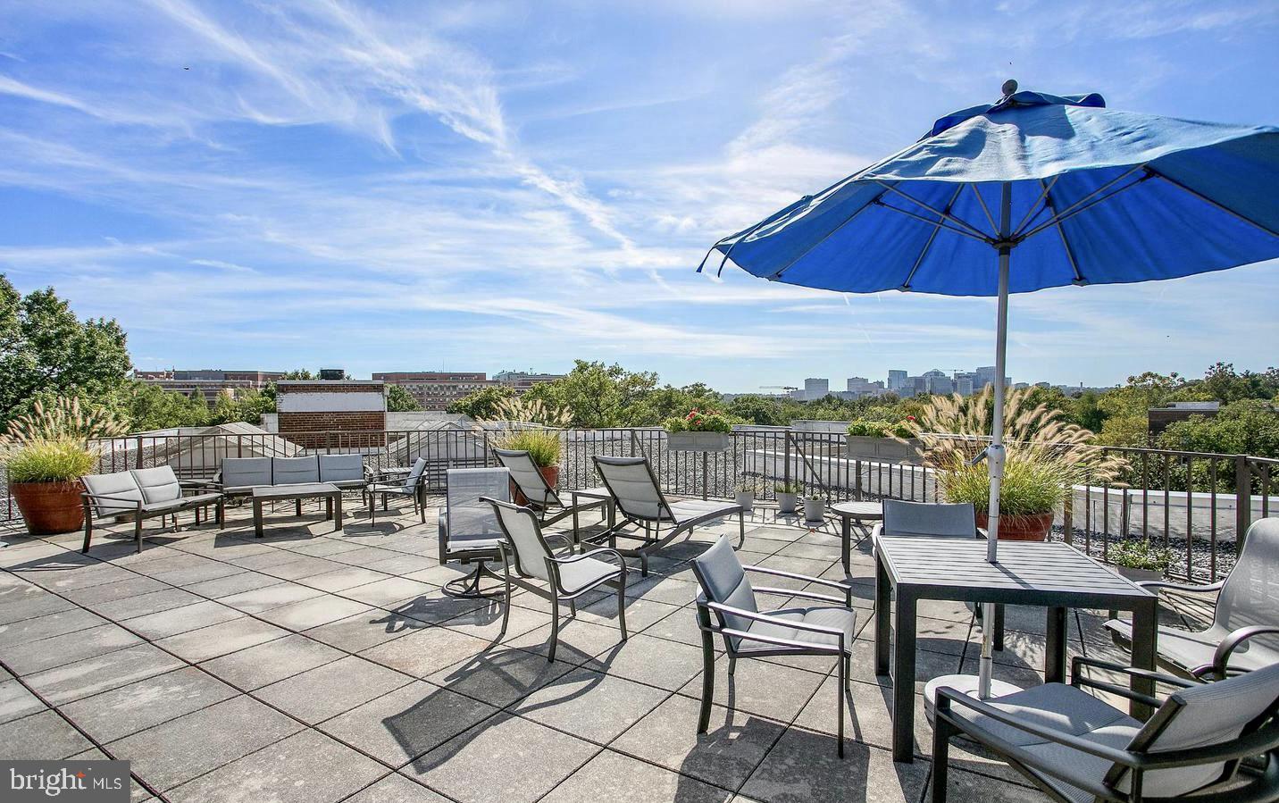 2500 Q Street Northwest, Unit 605 Washington, DC 20007 - Photo 28 of 48 a view of a terrace with furniture and umbrella