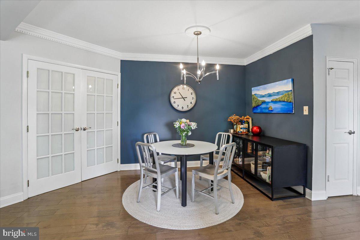 2500 Q Street Northwest, Unit 605 Washington, DC 20007 - Photo 8 of 48 a view of a dining room with furniture wooden floor and chandelier