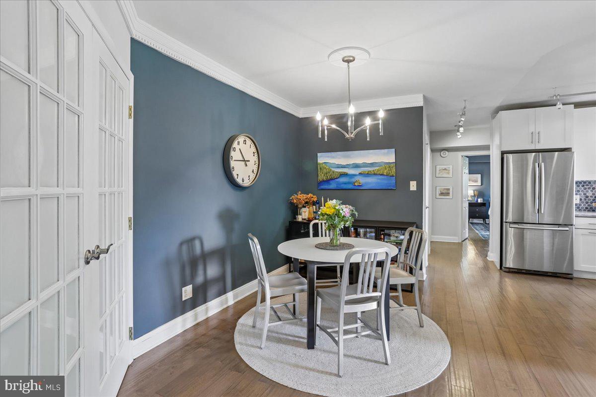 2500 Q Street Northwest, Unit 605 Washington, DC 20007 - Photo 10 of 48 a view of a dining room with furniture a chandelier and wooden floor