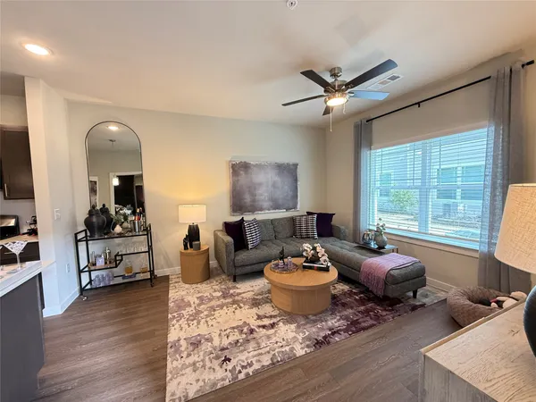 a living room with furniture window and wooden floor