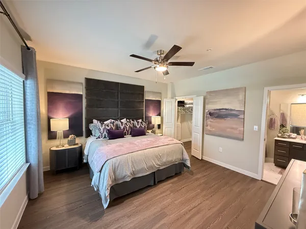 a bedroom with a bed a couch and dresser