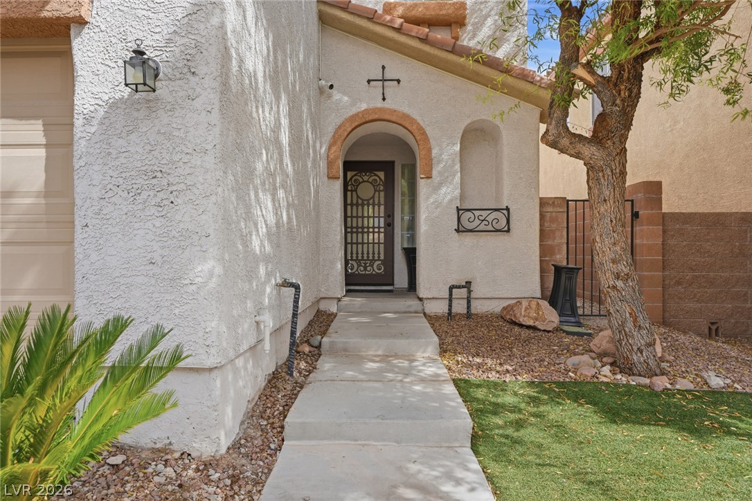 8932 Caledon Ridge Court Las Vegas, NV 89149 - Photo 13 of 39 An arched entry porch leads to the front door of this stucco exterior home.