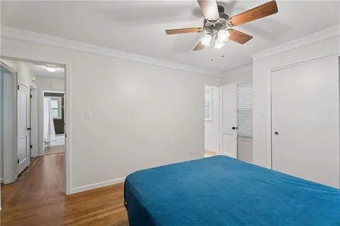 a view of a livingroom with wooden floor and a ceiling fan