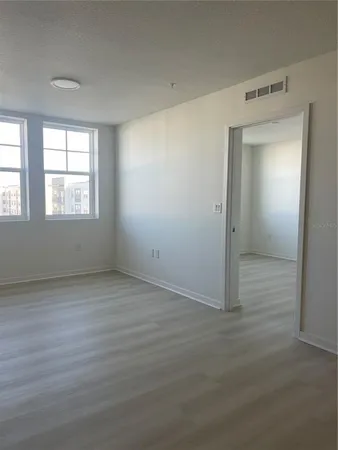 an empty room with windows and closet