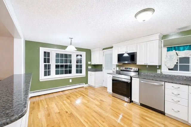 a kitchen with stainless steel appliances granite countertop a stove and a sink