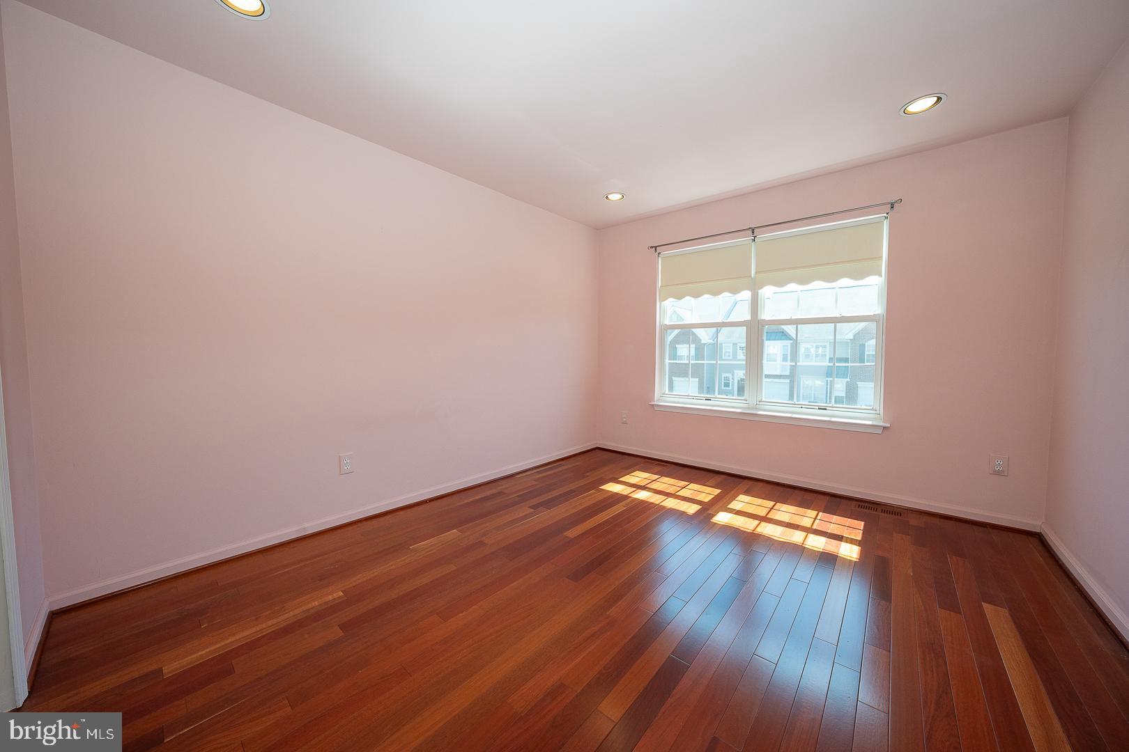 234 Lookout Place Wayne, PA 19087 - Photo 19 of 32 an empty room with wooden floor and windows