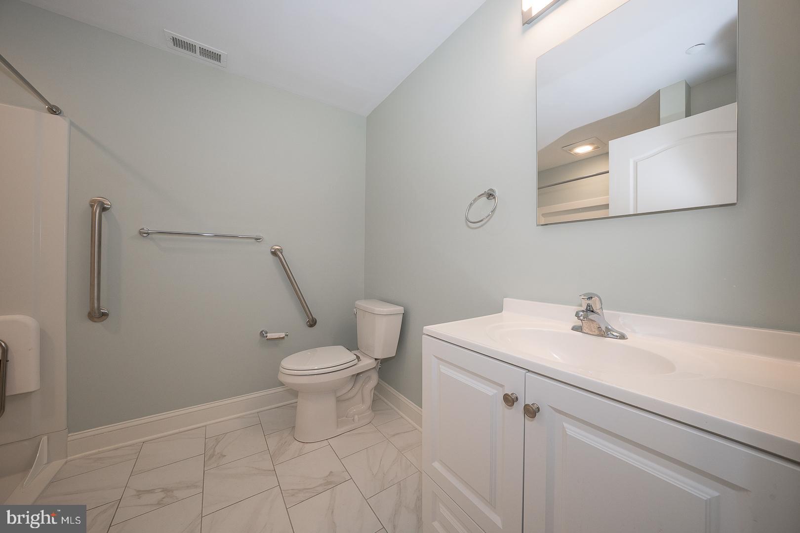 234 Lookout Place Wayne, PA 19087 - Photo 28 of 32 a bathroom with a sink a toilet and a mirror