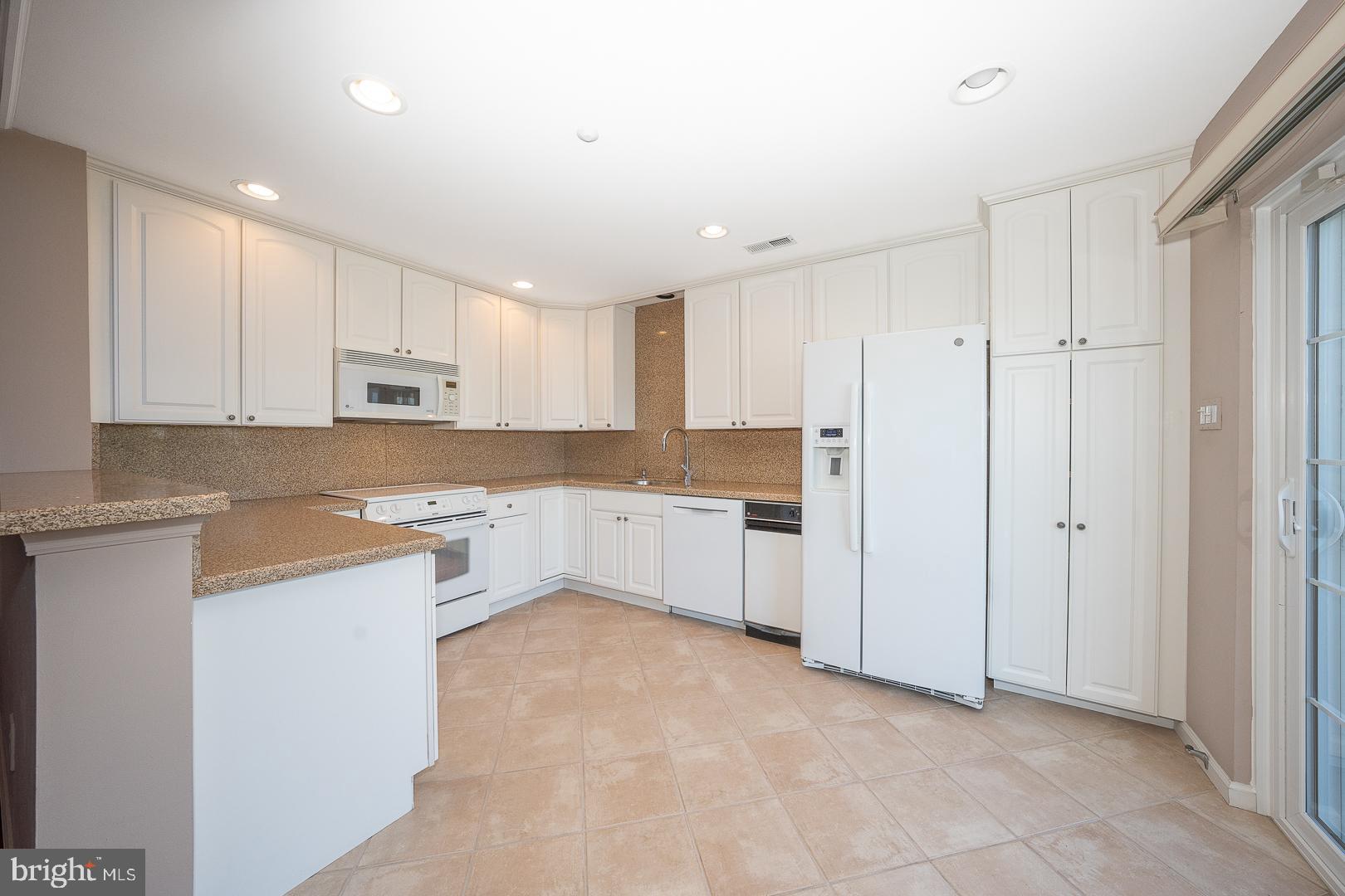234 Lookout Place Wayne, PA 19087 - Photo 7 of 32 a kitchen with white cabinets and white appliances