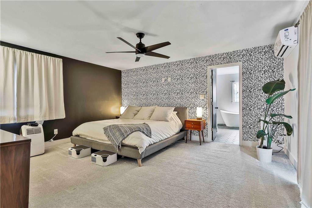 511 East Boyd Road Hogansville, GA 30230 - Photo 14 of 28 a spacious bedroom with a bed and a chandelier