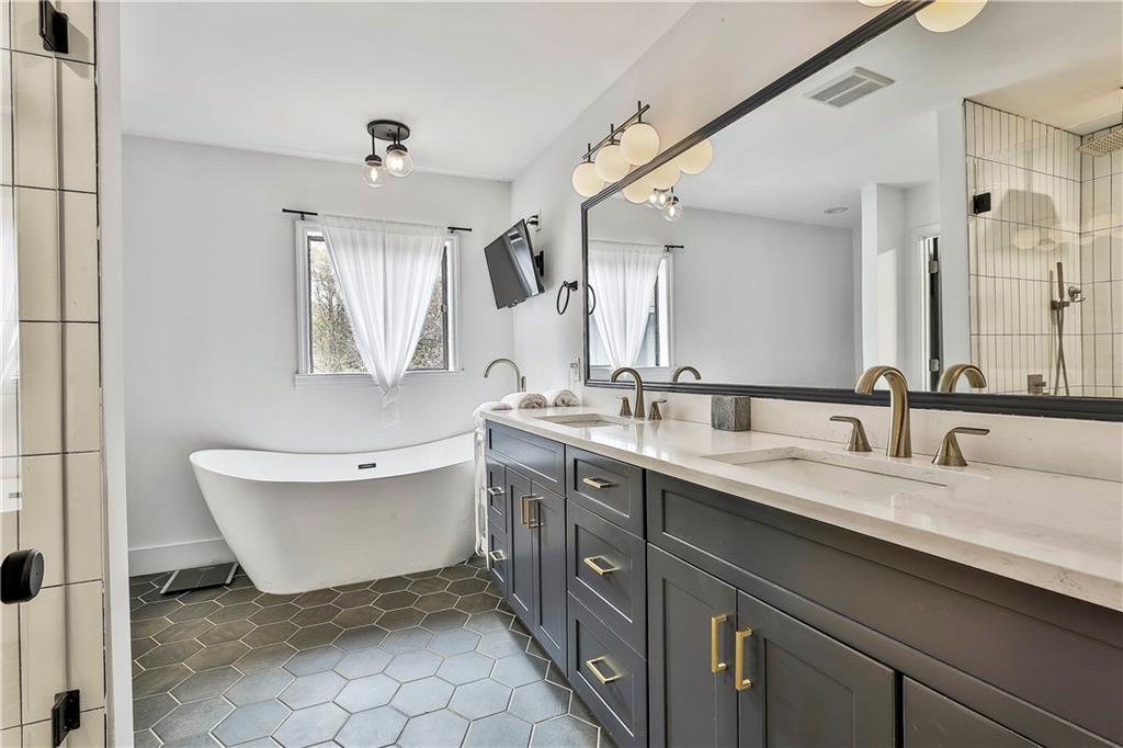 511 East Boyd Road Hogansville, GA 30230 - Photo 15 of 28 a spacious bathroom with a double vanity sink mirror and bathtub
