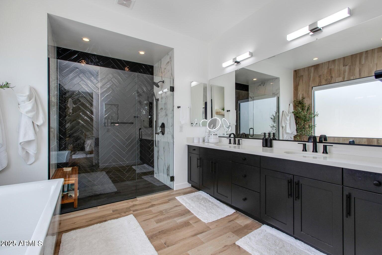 100 West Northern Avenue, Unit 17 Phoenix, AZ 85021 - Photo 12 of 20 a spacious bathroom with a double vanity sink a large mirror and a shower