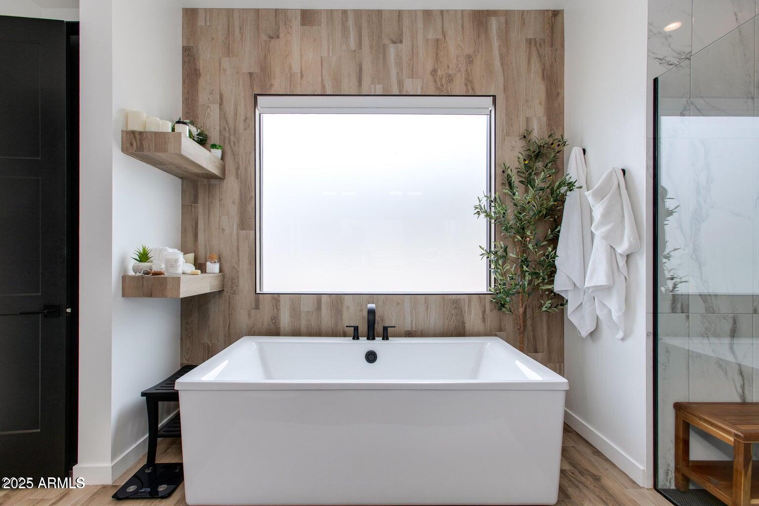 100 West Northern Avenue, Unit 17 Phoenix, AZ 85021 - Photo 13 of 20 a bath tub sitting in a bathroom next to a window