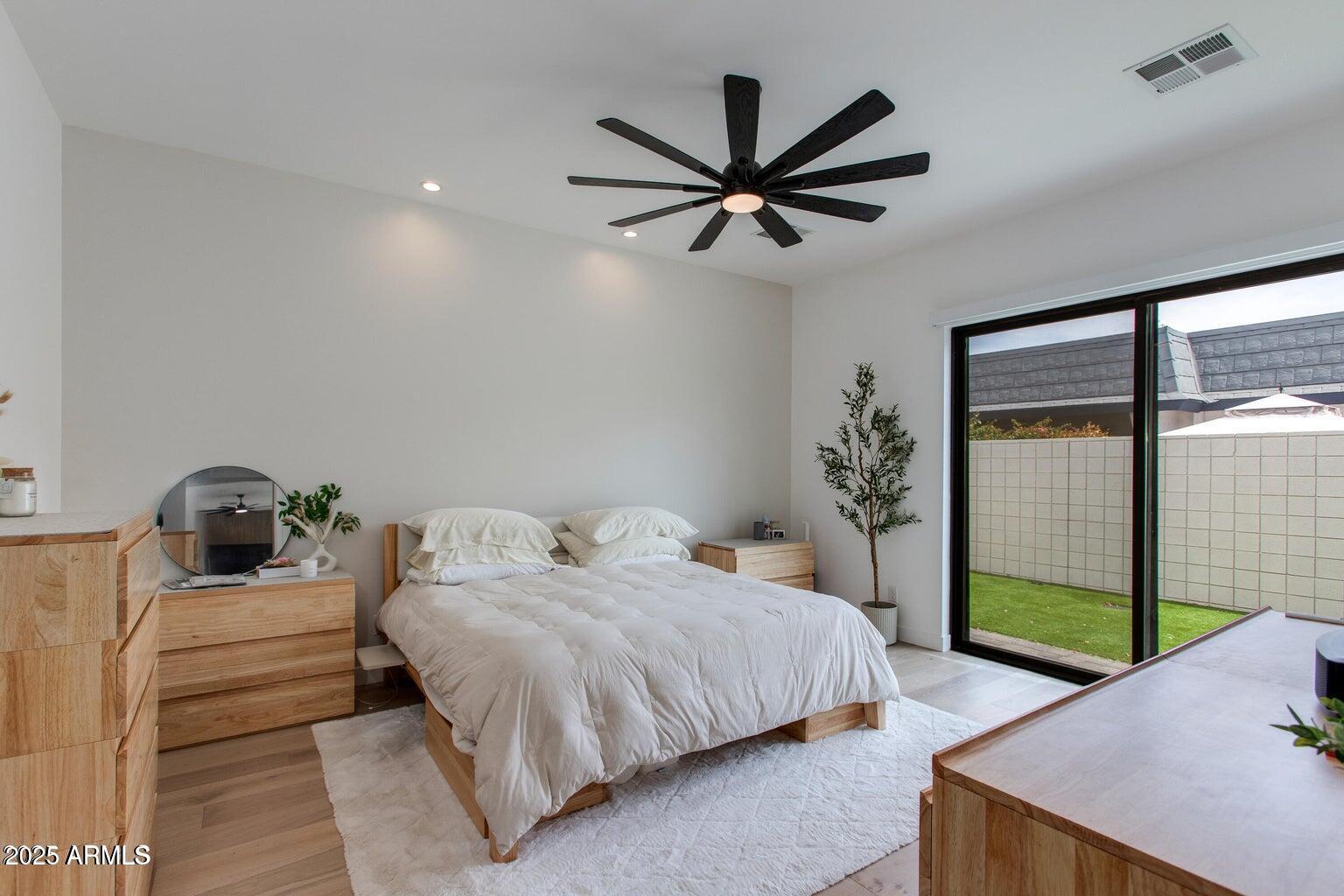100 West Northern Avenue, Unit 17 Phoenix, AZ 85021 - Photo 14 of 20 a bedroom with a bed and a chandelier