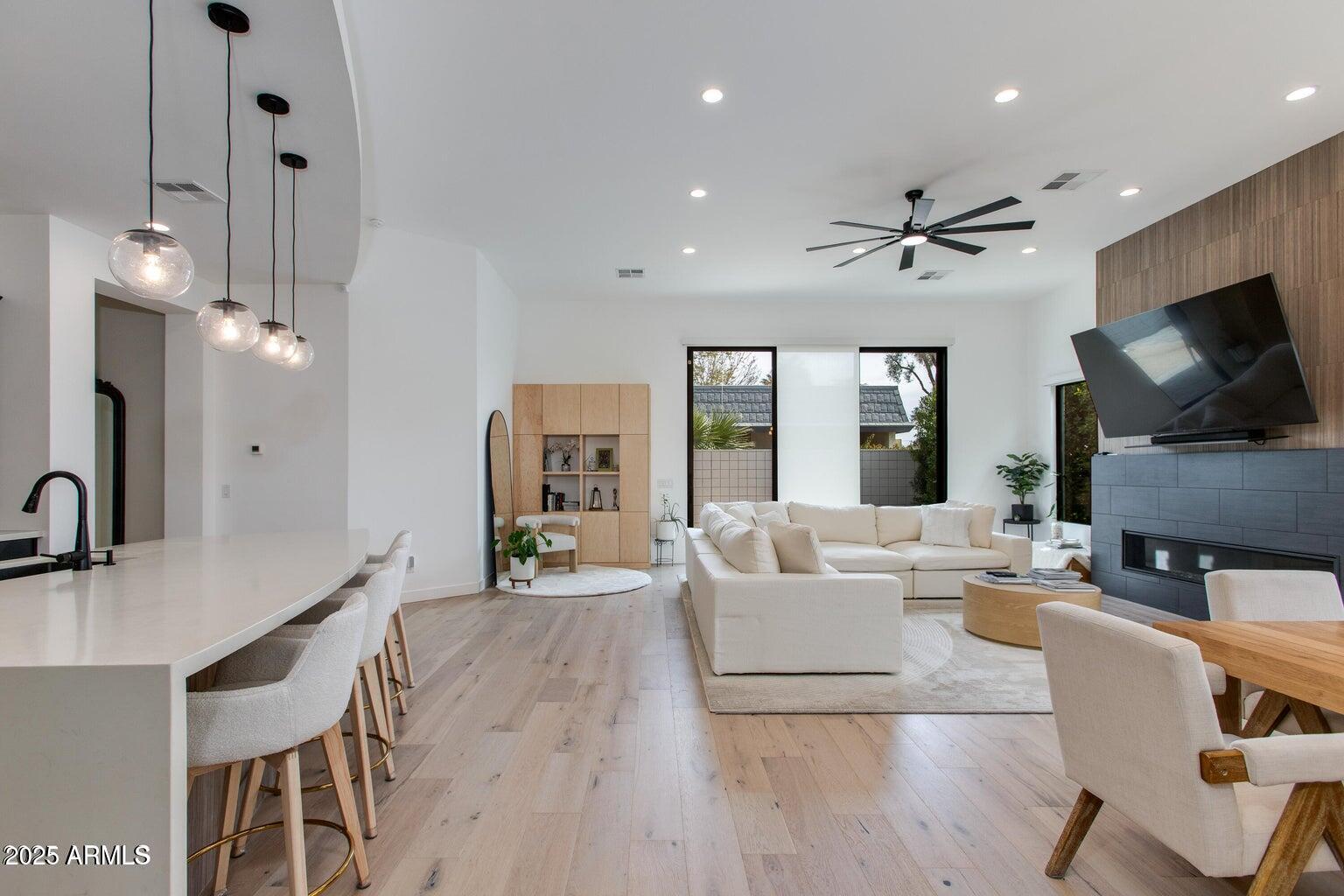 100 West Northern Avenue, Unit 17 Phoenix, AZ 85021 - Photo 6 of 20 a living room with furniture a flat screen tv and kitchen view